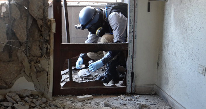 A United Nations (UN) arms expert collects samples, as he inspect the site where rockets had fallen in Damascus' eastern Ghouta suburb during an investigation into a suspected chemical weapons strike near the capital (File)