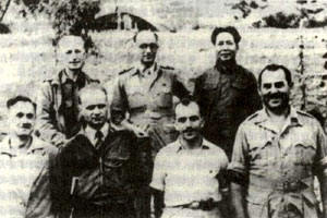 Israel Epstein, second from right in front, standing in front of Mao. He later became of his ministers of state, an extremely powerful position. To the right of him is another Jew, also under cover as a journalist.