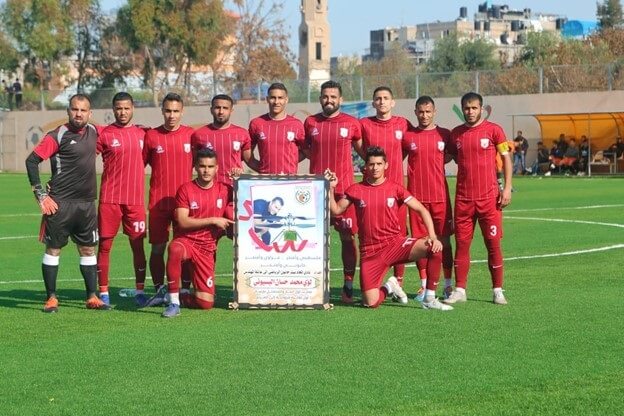 The Beit Hanoun soccer team presents a congratulatory poster to Elbasyouni’s family.