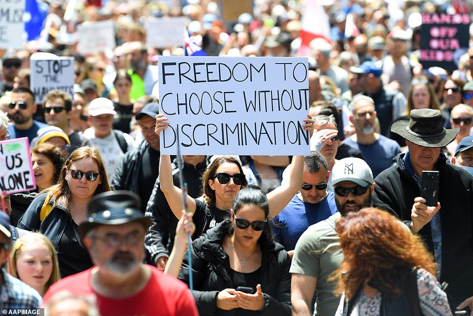 One protester marching in Melbourne waves a sign that reads: 'Freedom to choose without discrimination'