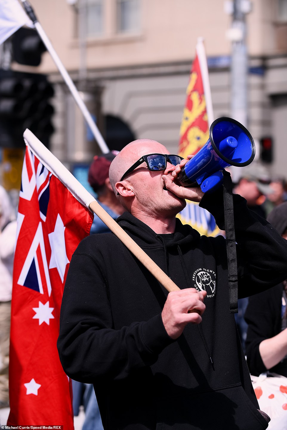 A demonstrator chants over the megaphone as the protesters march in Melbourne on Saturday