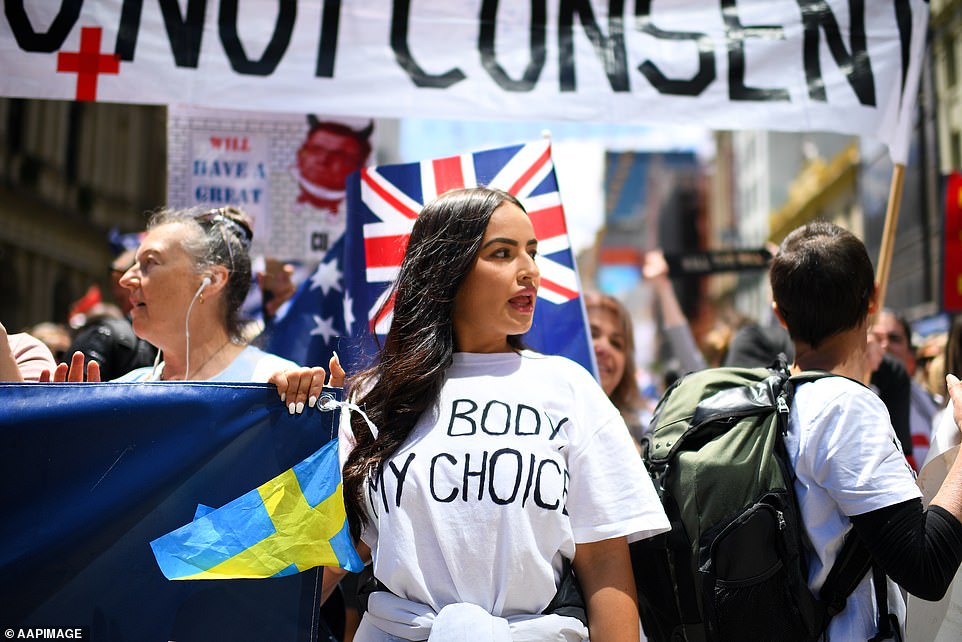 A 'freedom rally' protester wearing a 'My Body, My Choice' t-shirt marches on the street in Melbourne