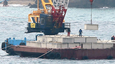 A crane barge works in the Henoko coastal area in Nago, Okinawa © AFP