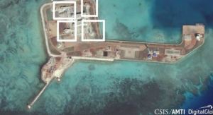 A satellite image shows what CSIS’s Asia Maritime Transparency Initiative says appears to be anti-aircraft guns and what are likely to be close-in weapons systems (CIWS) on the artificial island Hughes Reef in the South China Sea in this image released on December 13, 2016. Courtesy CSIS Asia Maritime Transparency Initiative/DigitalGlobe/