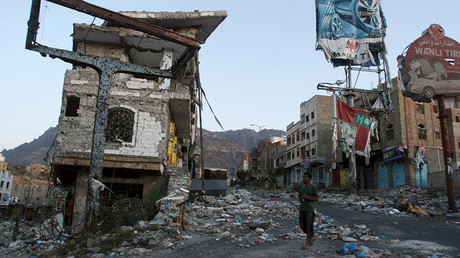 FILE PHOTO: A man walks past a destroyed building, in Yemen's southwestern city of Taiz. ©Anees Mahyoub 