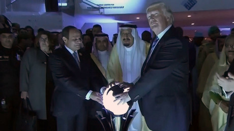 U.S. President Donald Trump places his hands on a glowing orb as he tours with other leaders the Global Center for Combatting Extremist Ideology in Riyadh, Saudi Arabia May 21, 2017. © Saudi TV