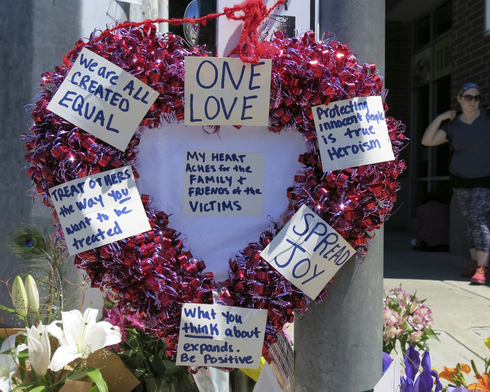 A wreath covered with positive messages hangs at a memorial for two bystanders who were stabbed to death Friday, while trying to stop a man who was yelling anti-Muslim slurs and acting aggressively toward two young women, including one wearing a hijab on a light-trail train in Portland, Ore, May 27, 2017.  (AP Photo/Gillian Flaccus)