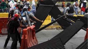 Protesters blocking a highway in Caracas, using fencing to create a barricade. (AVN)