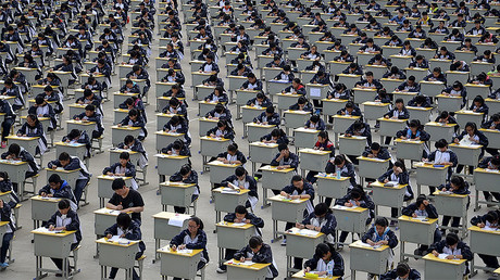 Students take an examination on an open-air playground at a high school in Yichuan, Shaanxi province. © Stringer