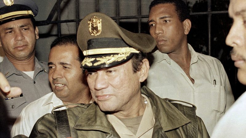 Manuel Antonio Noriega waves to supporters, in the presidential palace in Panama City. Noriega, a onetime U.S. asset who later was ousted by an American invasion in 1989, died late Monday, May 29, 2017, at age 83. (AP/John Hopper)