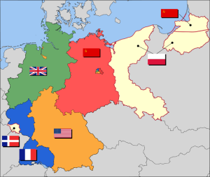 Post-WW II German occupation borders and territories. Areas in beige indicate territories east of the Oder-Neisse line that were attached to Poland and the USSR. The Saar Protectorate, on the lefthand side of the map, is also shown in beige.  Berlin is the multinational area shown within the red Soviet zone. (source: Wikipedia)