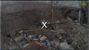 Screen shot of police body cam in Baltimore showing police planting evidence.