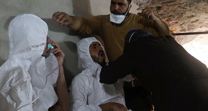 A man breathes through an oxygen mask as another one receives treatments, after what rescue workers described as a suspected gas attack in the town of Khan Sheikhoun in rebel-held Idlib, Syria