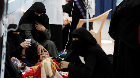 Women help a young relative infected with cholera at a hospital in Sanaa. © Khaled Abdullah