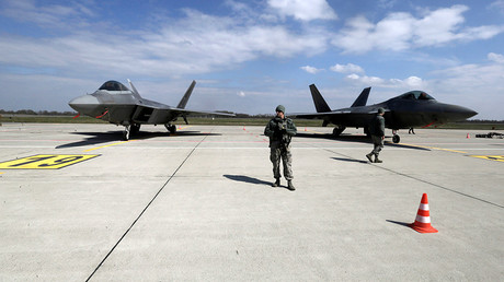 FILE PHOTO U.S. Army soldiers guard as U.S. Air Force F-22 Raptor fighters are parked in the military air base in Siauliai, Lithuania © Ints Kalnins