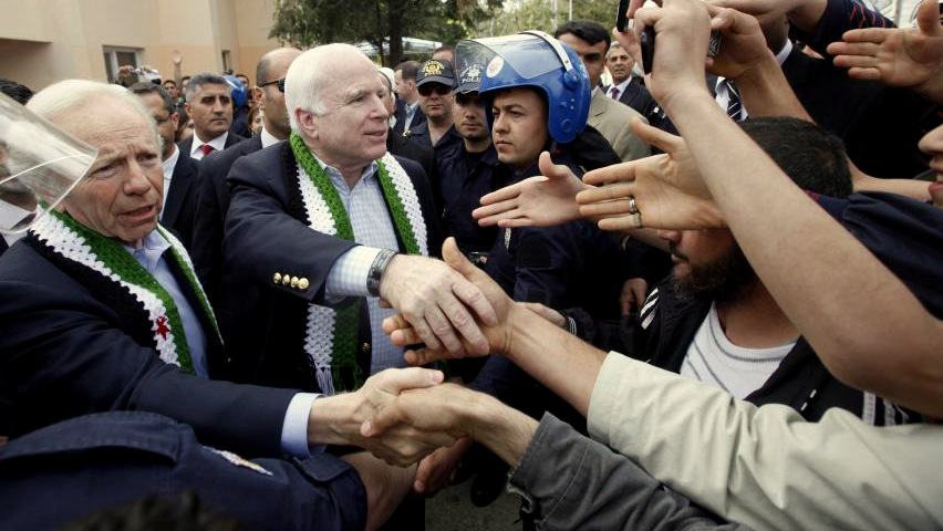 U.S. Senators John McCain (R-AZ) and Joseph Lieberman (D-CT) greet men at a refugee camp during a visit to the Turkish-Syrian border April 10, 2012. (Umit Bektas/Reuters)