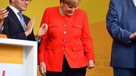   German Chancellor Angela Merkel looks at a stain on her jacket during a campaign event at the University Square in Heidelberg, Germany, 5 September 2017. © Uwe Anspach / dpa / Global Look Press