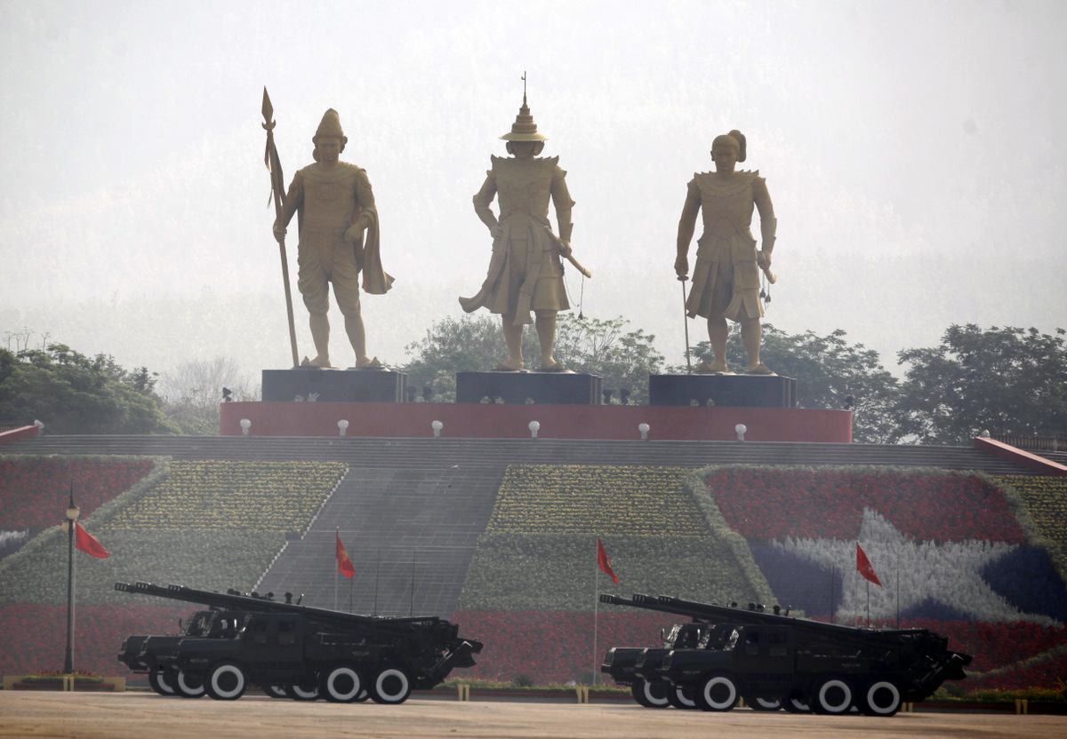 Myanmar military soldiers salute from vehicles carrying rockets as they leave the venue during a parade to commemorate the Myanmar's 72nd Armed Forces Day in Naypyitaw, Myanmar, Monday, March 27, 2017. Myanmar marks 72nd Armed Forces Day, which commemorates the start of the revolt by the Burma National Army under the country's hero General Aung San against its former ally, the Japanese Imperial Army, in 1945. The country's military ruled the country with iron fist for more than half a century. (AP Photo/Aung Shine Oo)