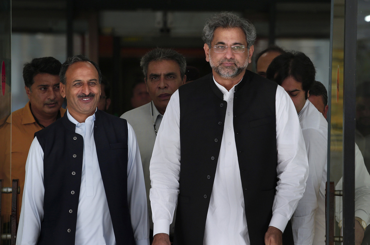 Pakistan's premier-designate Shahid Khaqan Abbasi, right, leaves with his aids after meeting with politicians in Parliament house in Islamabad, Pakistan, Monday, July 31, 2017. Pakistan's parliament will meet Tuesday to elect a new prime minister after the disqualification of three-term prime minister Nawaz Sharif. Sharif's Pakistan Muslim League party nominated Sharif's longtime loyalist Abbasi for the top slot on Saturday. (AP Photo/Anjum Naveed)