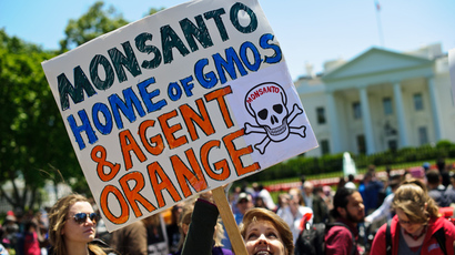 People hold signs during a demonstration against agribusiness giant Monsanto and genetically modified organisms (GMO) in front of the White House in Washington (AFP Photo / Nicholas Kamm) 