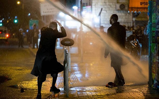 Ultra-Orthodox demonstrators during a protest against the jailing of Jewish seminary student who failed to comply with an army recruitment order, in Jerusalem's Mea Shearim neighborhood, February 7, 2017. (Yonatan Sindel/Flash90)