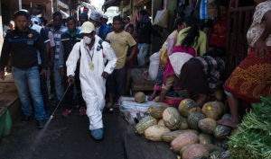 Health workers disinfecting a market.