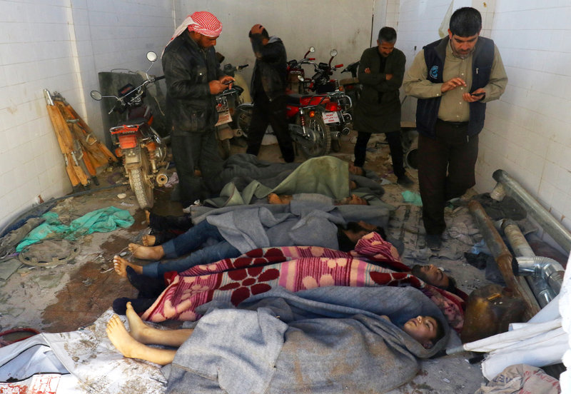 Bodies are wrapped in blankets after a suspected chemical attack in the town of Khan Sheikhoun. (Ammar Abdullah/Reuters)