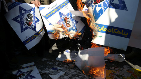 Iranians burn Israeli flag posters during a protest against US President Donald Trump's decision to recognise Jerusalem as the capital of Israel, in Tehran, Iran December 8, 2017 © Tasnim News Agency