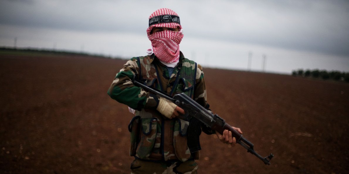 A Free Syrian Army fighter takes position close to a Syrian military base near Azaz, Syria, Dec. 10, 2012. (AP/Manu Brabo)