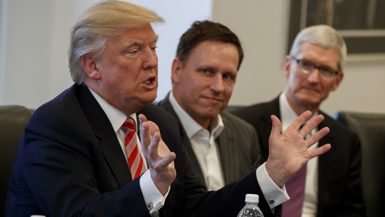 Palantir founder Peter Thiel, center, listens as President-elect Donald Trump speaks during a meeting with tech industry leaders at Trump Tower in New York, Apple CEO Tim Cook is pictured in the background. Dec. 14, 2016. (AP/Evan Vucci)