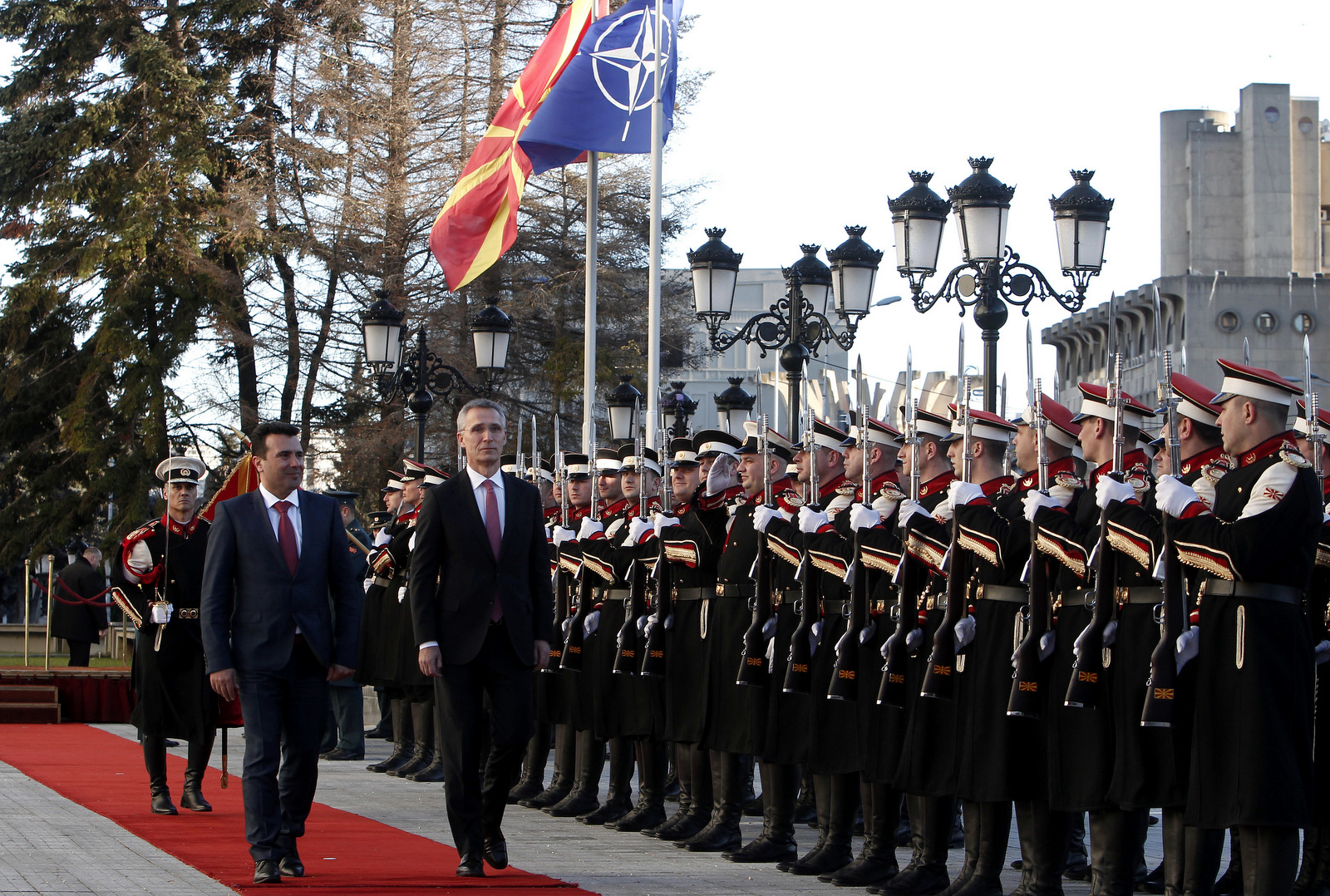 NATO Secretary General Jens Stoltenberg, second from left, accompanied by Macedonian Prime Minister Zoran Zaev, left, inspects an honor guard squad upon his arrival at the Government building in Skopje, Macedonia, Jan. 18, 2018. NATO's secretary-general urged Macedonia to solve its name dispute with Greece and proceed with wide-ranging reforms if it wants its membership bid to succeed. (AP/Boris Grdanoski)