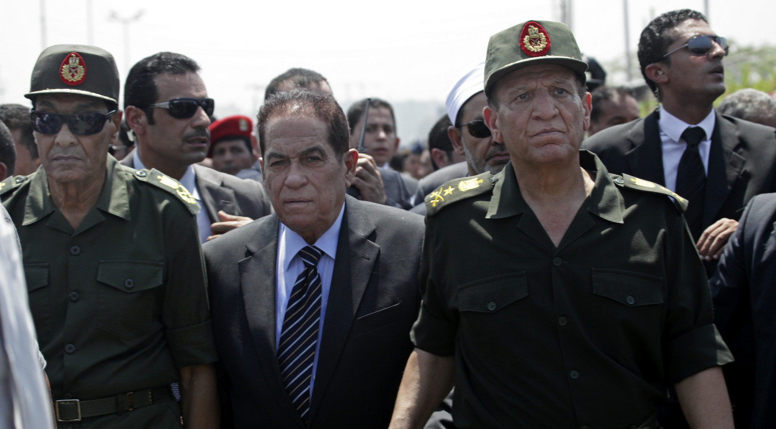 In this Aug. 7, 2012 file photo, Defense Minister Hussein Tantawi, left, former Prime Minister Kamal Ganzouri, center and Armed Forces Chief of Staff Sami Anan, attend the funeral of 16 soldiers killed in an attack over the weekend by suspected militants in Sinai in Cairo, Egypt . (AP/Thomas Hartwell)