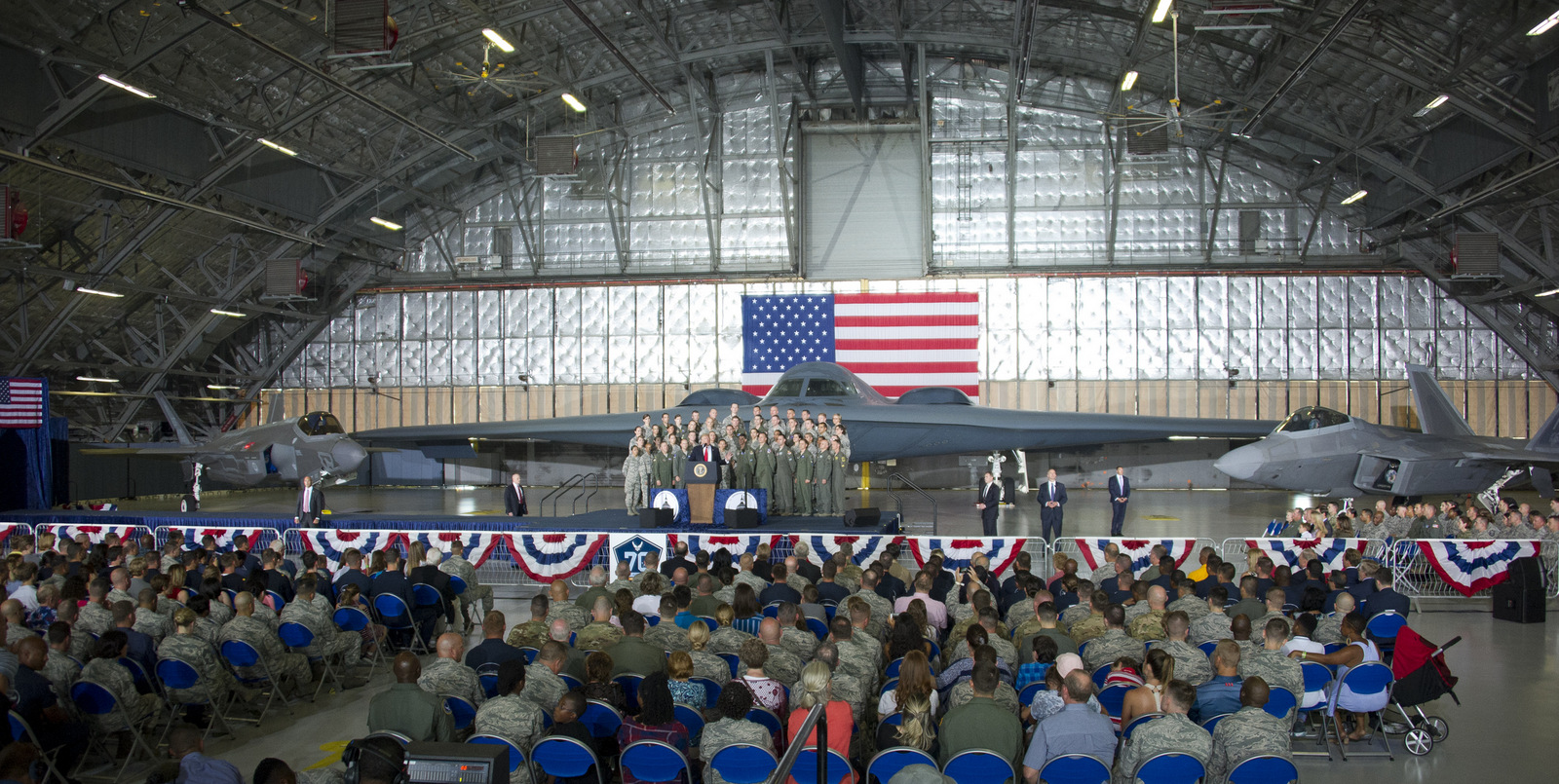 United States President Donald J. Trump delivers remarks to military personnel and families in a hanger at Joint Base Andrews in Maryland on, September 15, 2017.  He visited JBA to commemorate the 70th anniversary of the US Air Force.  In the background behind the group, from left is a F-35 Joint Strike Fighter, a B-2 Stealth Bomber and a F-22 fighter. (AP Photo)