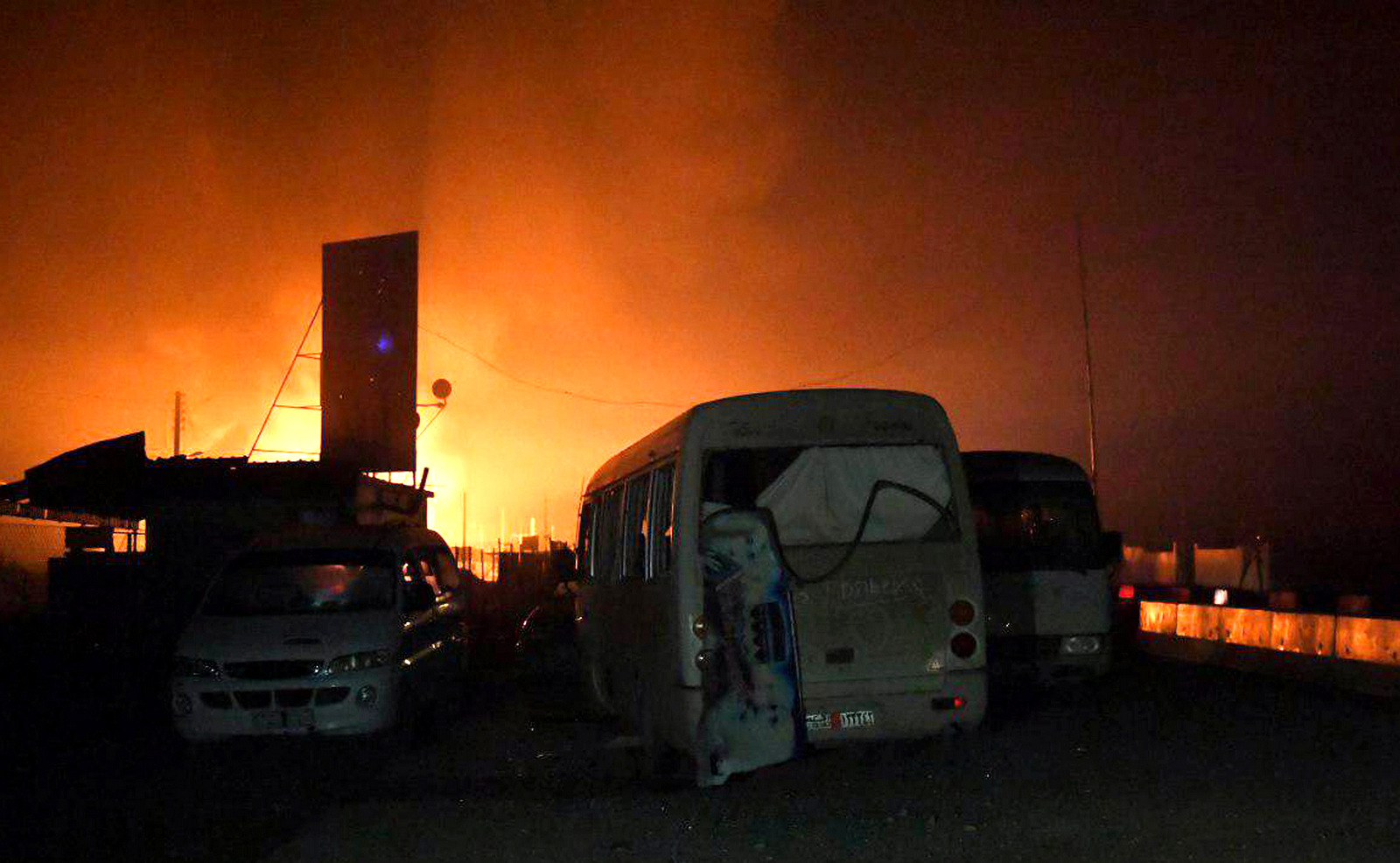 Flames rise from buses and trucks in a convoy headed to Afrin, Syria. According to Syrian state TV, a convoy carrying aid heading toward Afrin was targeted by Turkish artillery, in al-Ziara village. The incident, came two days after pro-government fighters began entering the predominantly Kurdish town to shore up the Kurdish forces, Feb. 23, 2018. (SANA via AP)