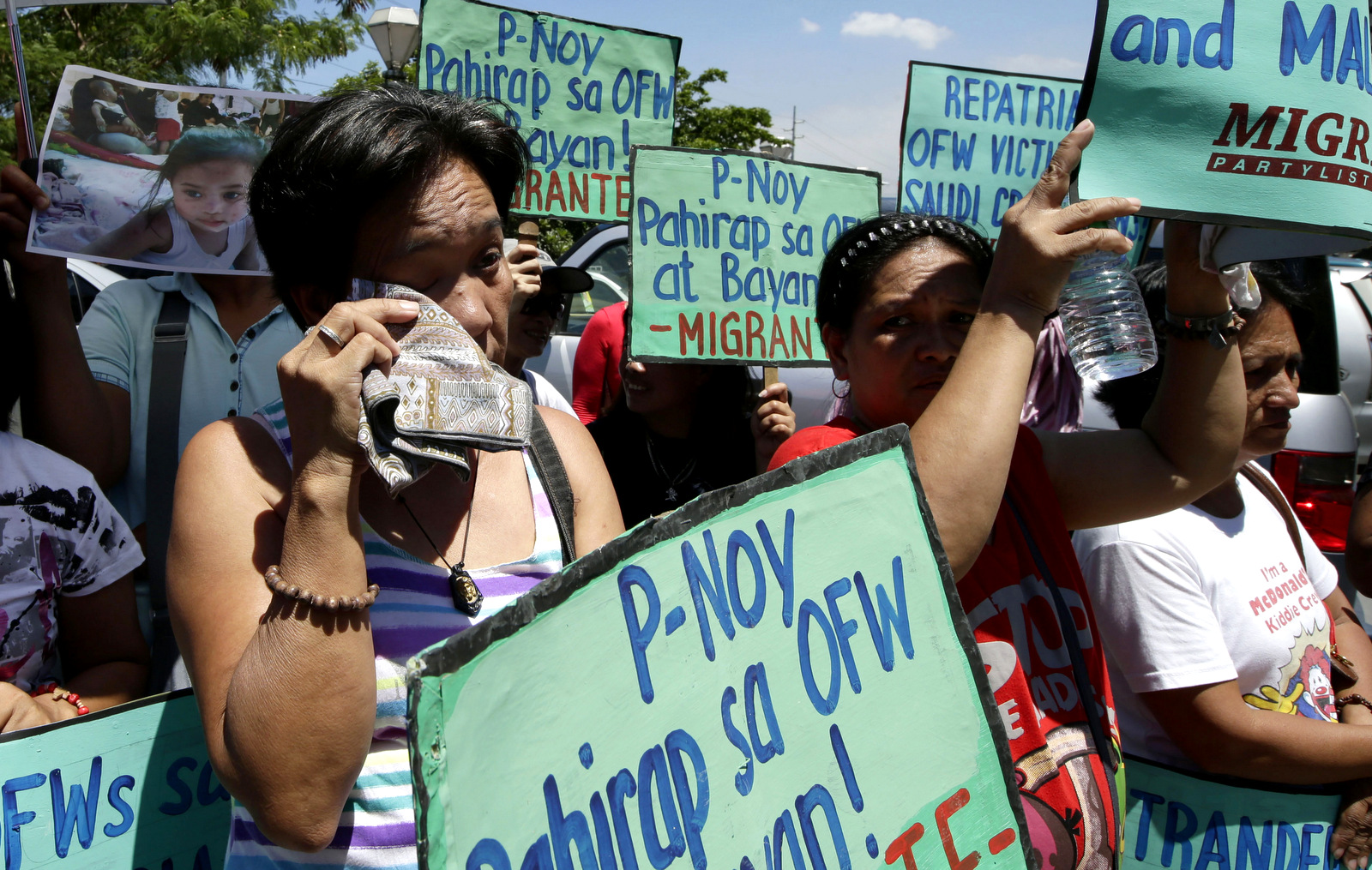 Relatives of OFWs (Overseas Filipino Workers) display placards as they pitch their tent to begin their planned three-day camp-out at the Department of Foreign Affairs in Manila, Philippines, Monday April 29, 2013. The camp-out was organized in sympathy with more than 2,500 who pitched their tents in Jedda, Saudi Arabia to escape alleged crackdowns on undocument overseas workers by the Saudi government. (AP/Bullit Marquez)