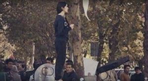 The ‘girl from Enghelab Street’, recorded holding her hijab aloft in protest in December 2017. The National via YouTube 