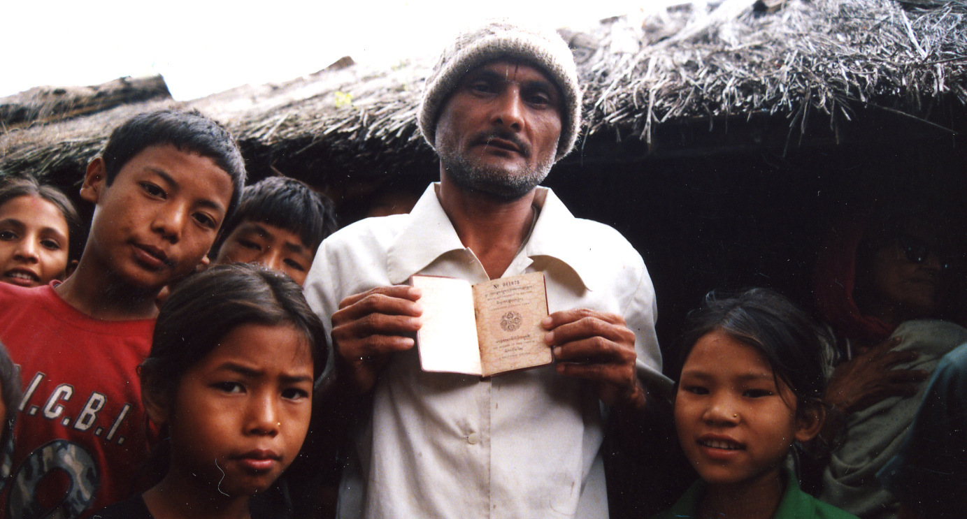 A refugee shows a Bhutanese passport from a refugee camp in Nepal.(Photo: Alemaugil/Wikimedia)
