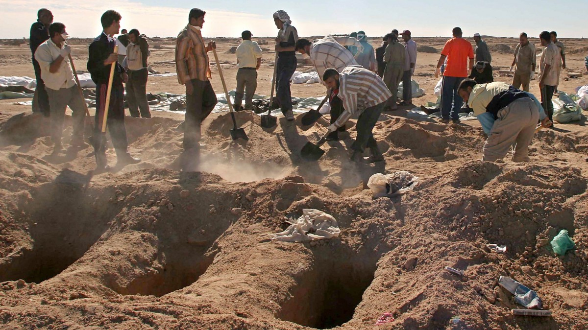 In this Friday, Nov. 10, 2006 photo, Iraqi volunteers bury bodies in the Shiite holy city of Najaf, 160 kilometers (100 miles) south of Baghdad, Iraq as 176 bodies of victims of recent violence were brought from Baghdad to Najaf for the funeral. (AP/Alaa al-Marjani)