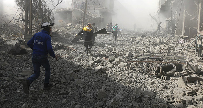 Members of the Syrian Civil Defense run to help survivors from a street that attacked by airstrikes and shelling of the Syrian government forces, in Ghouta, suburb of Damascus, Syria