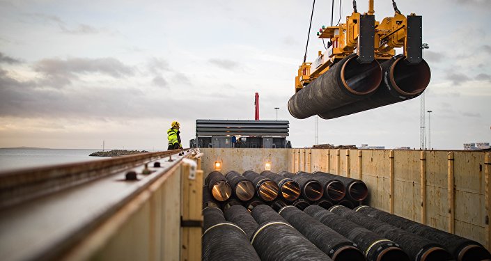 Pipes are loaded onto a vessel in the northern German port of Mukran for transshipment to a storage yard