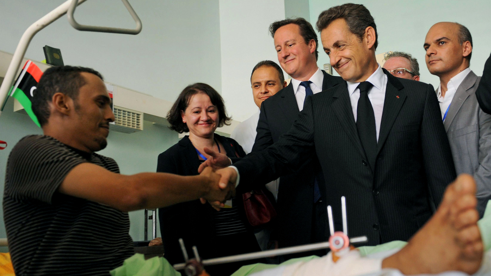 In a major endorsement for Libya's post-regime change rulers, French President Nicholas Sarkozy shakes hands with patient at the Tripoli Medical Center in Libya Thursday Sept. 15, 2011. (AP/Stefan Rousseau)