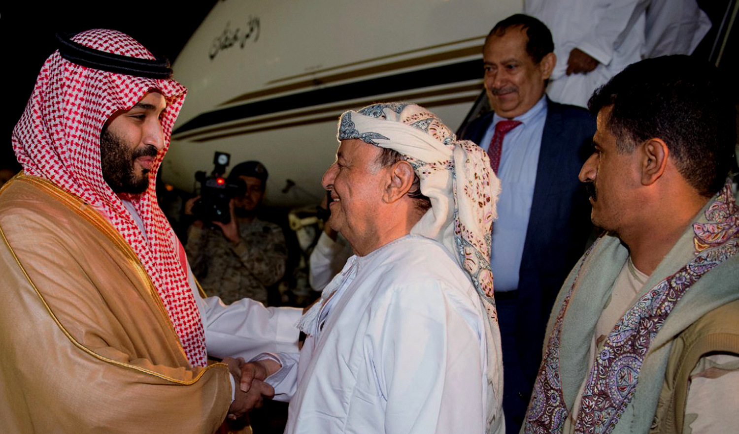 Saudi Prince Mohammed bin Salman, left, welcomes Yemen's Abed Rabbo Mansour Hadi as Hadi arrives at an airbase in Riyadh, Saudi Arabia, March 26, 2015. (AP Photo/SPA)