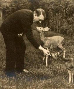 Adolf Hitler feeding baby deer.