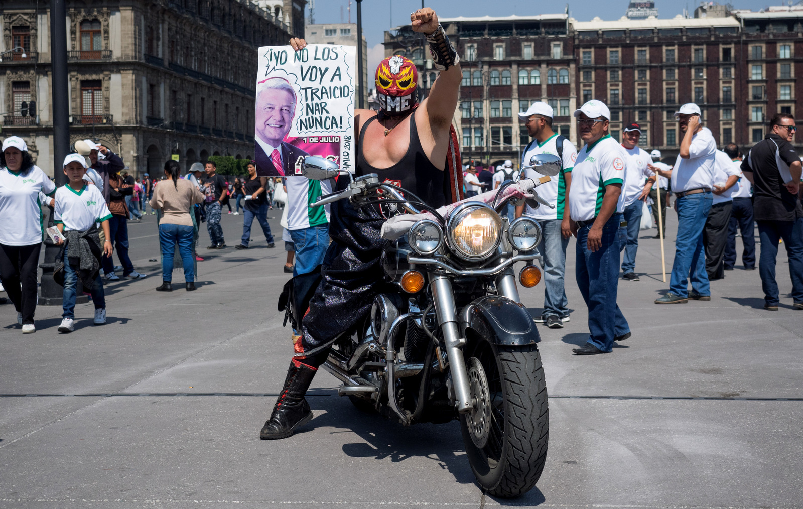 A supporter of the Mexican Union of Electrical Workers in his disguise as a luchador wrestler holds a sign showing support for leftist presidential candidate Andres Manuel Lopez Obrador in the Zocalo of Mexico City, May 1, 2018. (Photo: José Luis Granados Ceja)