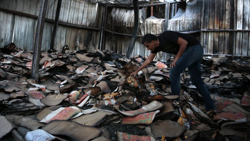 A man inspects a food factory hit by Saudi-airstrikes, in Sanaa, Yemen. Human rights experts say there has been a pattern by the Saudi-coalition in failing to distinguish between civilian and military targets and disregarding the likelihood of civilian casualties, likely amounting to war crimes. (AP/Hani Mohammed)