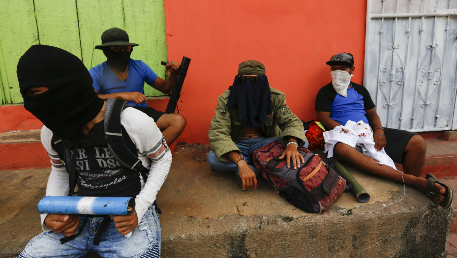 Masked protesters sit with their mortars on a stoop in the Monimbo neighborhoodm in Masaya, Nicaragua, Saturday, June 2, 2018. Alfredo Zuniga | AP