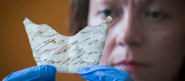 Curator, Anna Forrest, holds up one of the discoveries found under the floorboards of Oxburgh Hall. (National Trust)