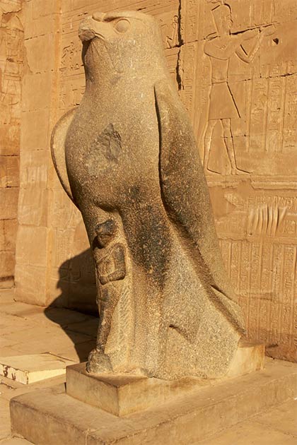 Closeup of the god Horus statue in front of the pylon temple entranceway (Walwyn / Flickr)