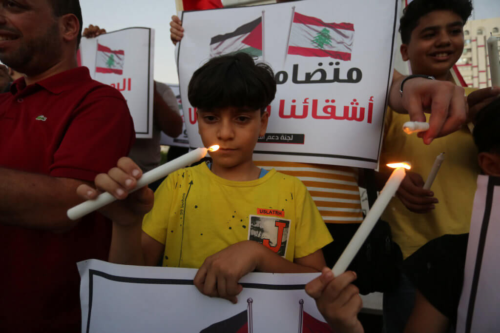 Palestinian children take part in a candlelight vigil in solidarity with the Lebanese people, in Gaza city on August 6, 2020. (Photo: Ashraf Amra/APA Images)