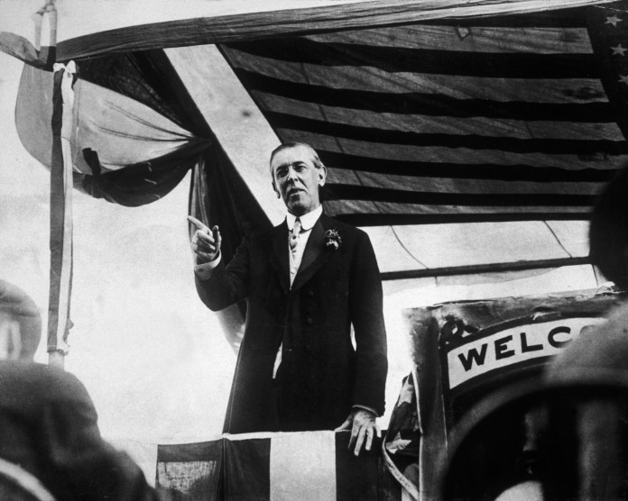 President Woodrow Wilson, speaking from a platform.